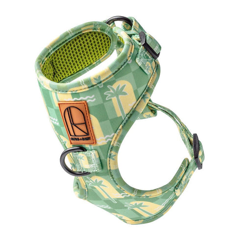 Green patterned dog harness on a white background